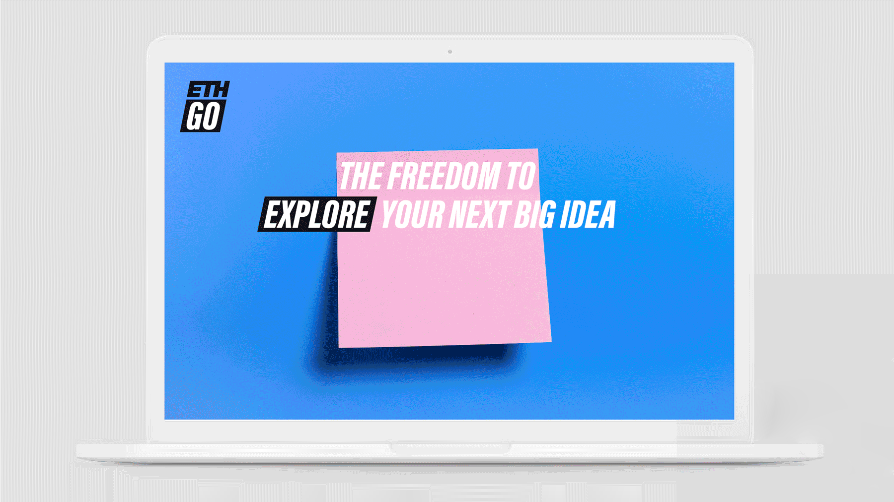 A laptop screen reading 'The freedom to explore your next big idea' beside the ETH GO logo, with an animated sticky note